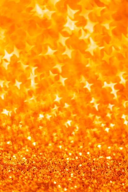 圣诞背景-星星形状的散景在金色调图片下载