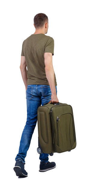 后视图行走的人与手提箱。图片下载