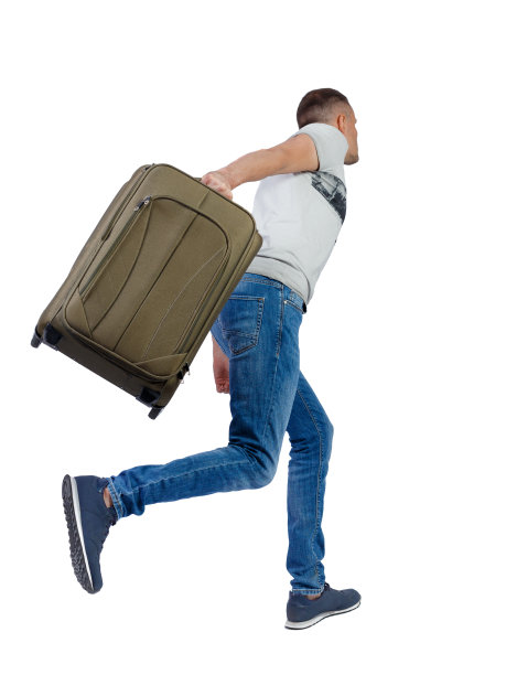 后视图行走的人与手提箱。图片下载