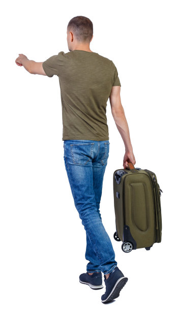 后视图行走的人与手提箱指向。图片下载