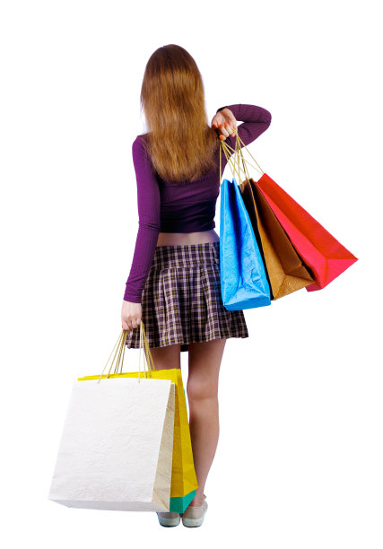 后视图的女人与购物袋。图片下载