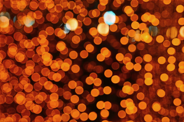 橙色抽象的模糊和散景色彩的灯光和夜晚花园图片下载