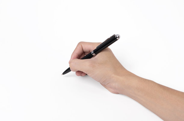 手握笔写在白色的背景，特写。图片下载