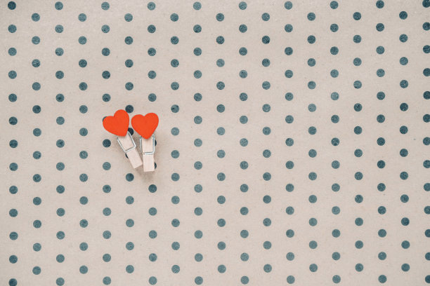 两颗心在一个精心制作的圆点背景。假期的概念。平铺，俯视图，拷贝空间。情人节的背景。图片下载
