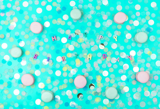 节日公寓摆放着彩色的圆纸屑和杏仁饼干，背景是时尚的薄荷。生日快乐文本。节日的概念。图片下载