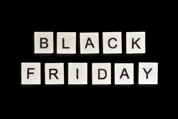 一块自制的木瓷砖，橙色背景上有“黑色星期五”字样图片下载