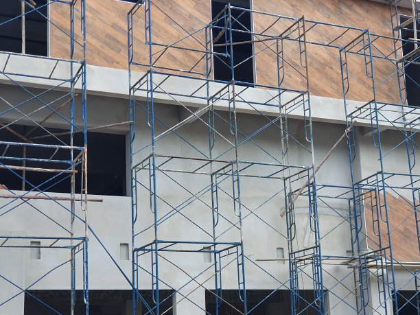 旧的蓝色钢脚手架在正在建造的建筑前图片下载