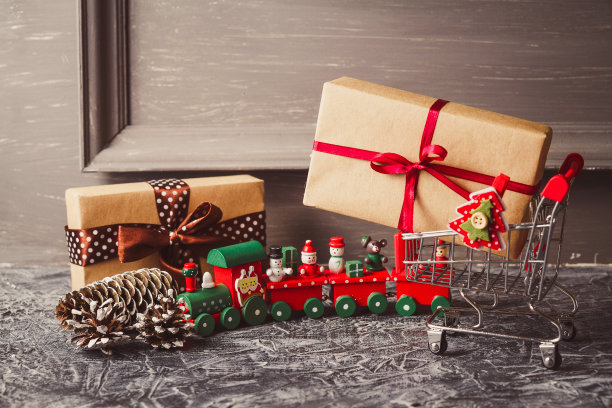 在水泥桌上放着装有礼物的购物车。圣诞和新年销售理念。图片下载