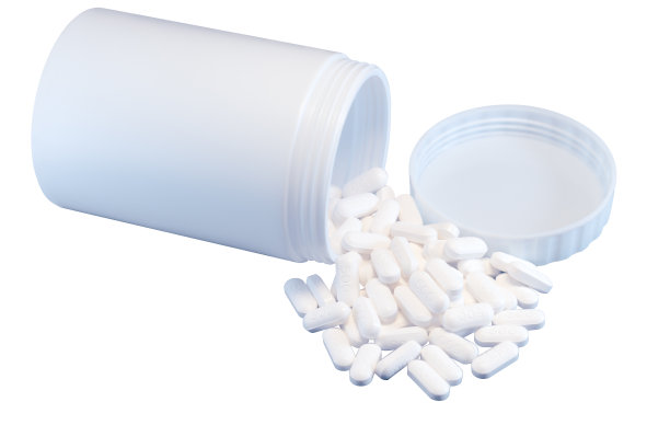 孤立的白色药丸和白色瓶子在白色背景。图片下载