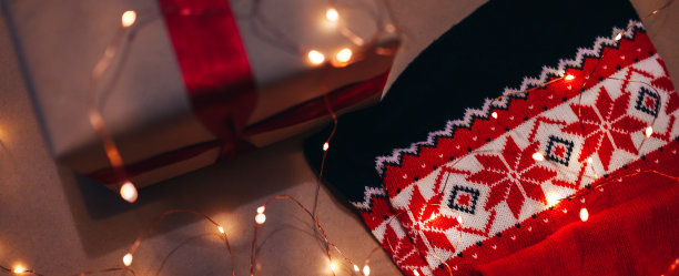 温馨的冬日圣诞照片。礼品用牛皮纸包好，上面装饰着糖果藤，以牛皮纸为背景。圣诞节的概念。新年的概念。礼物。礼物。假期图片下载