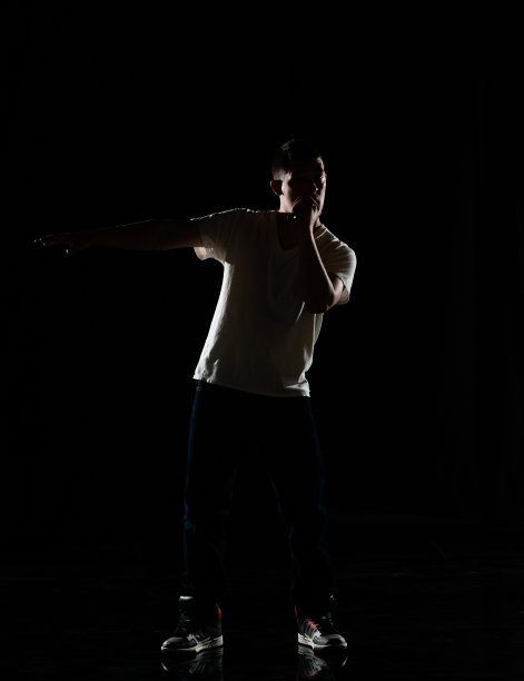 全长/一人/一人/正面观看20-29岁的成年英俊的人白人男性/年轻男子歌手/音乐家站/舞蹈在黑色背景穿着帆布鞋/牛仔裤/裤子/ t恤/衬衫图片下载