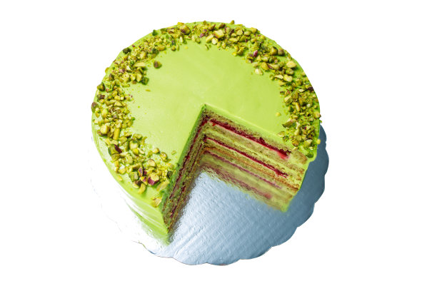 蛋糕与水果奶油和开心果装饰与坚果，孤立。食品的背景图片下载