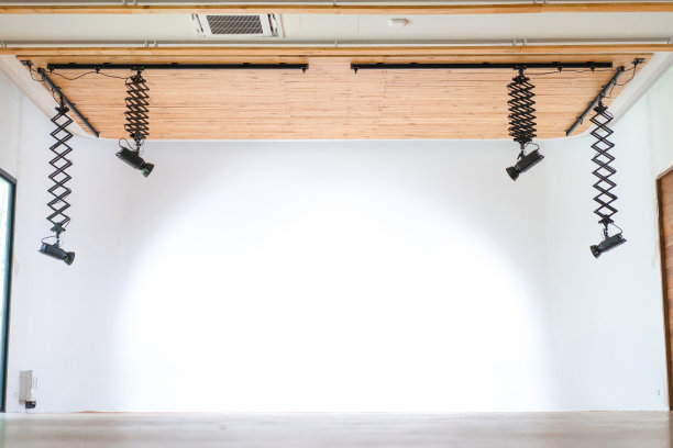 专业工作室大厅悬挂木质天花板的LED灯，后面是无边无际的白色墙壁。图片下载