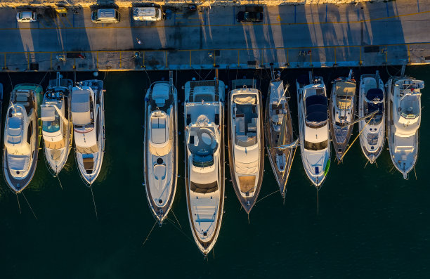 游艇和船只的鸟瞰图停泊在码头和清澈的水在日落图片下载