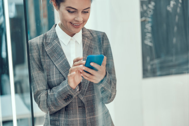 微笑手机用户在办公室库存照片图片下载