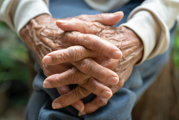 两个满脸皱纹的老人交叉着双手图片下载