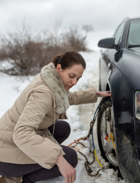漂亮女人在车上安装雪链图片下载