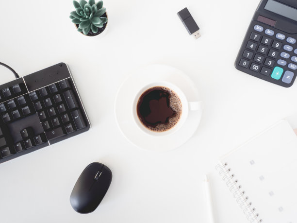 顶视图的办公桌桌子与咖啡杯和笔记本在白色的背景，平面设计师，创意设计师的概念。图片下载