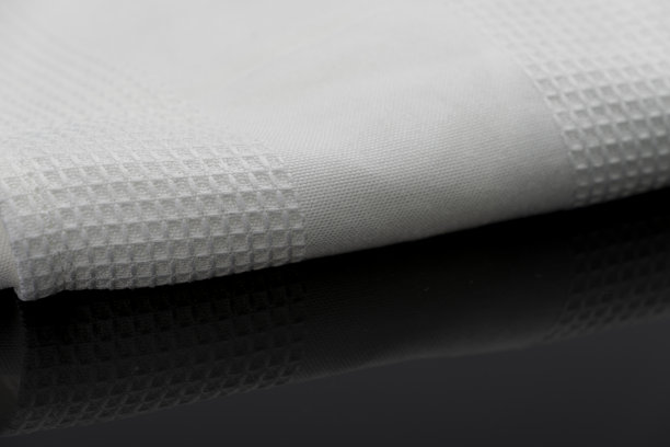 折叠的白色毛巾厨房织物的微距拍摄纹理图案图片下载