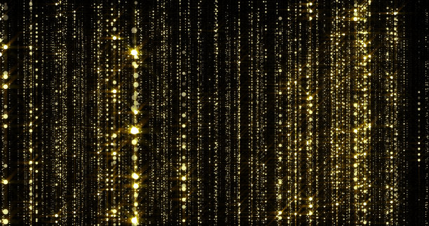 金色的闪光和金色的颗粒雨，流动的光帘与散景的火花丝线背景图片下载