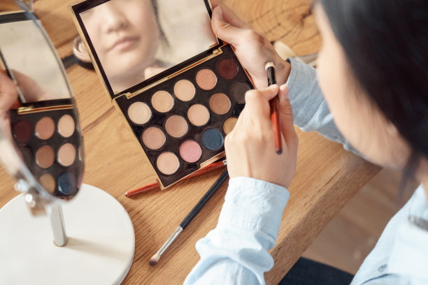 年轻的成年亚洲女孩选择化妆品化妆图片下载
