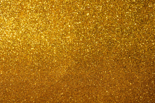 金色模糊闪闪发光的背景。圣诞灯。图片下载