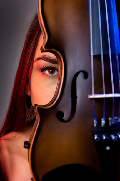 女艺术家躲在小提琴后面图片下载