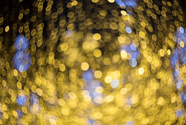 黄色和蓝色的散景灯作为背景纹理。模糊抽象的图像像一个背景。图片下载