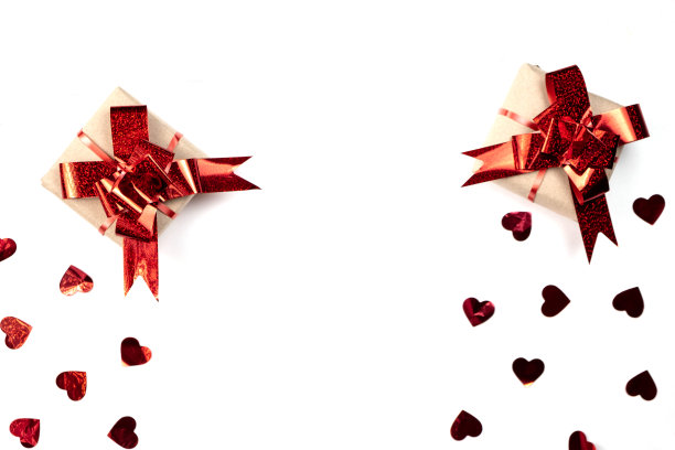 节日的背景。手工礼盒装饰红心纸屑在白色的背景。简约风格和情人节概念。平铺，俯视图，拷贝空间图片下载