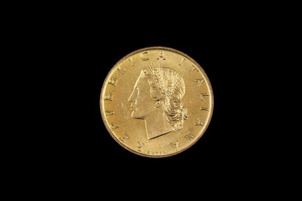 在黑色背景下拍摄的一枚古老的意大利里拉硬币图片下载