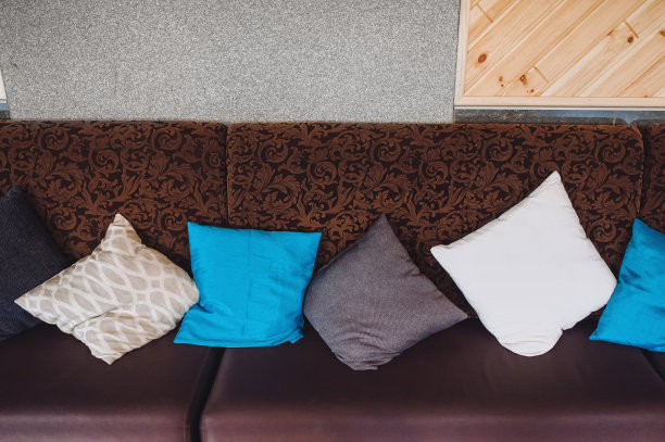 餐厅的沙发上放着五颜六色的枕头。为人们提供休息和睡眠的地方。图片下载