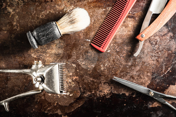 美发剪刀，老式手工剪，梳子，刷子，危险的剃须刀，都在一个生锈的老漂亮的表面上。图片下载