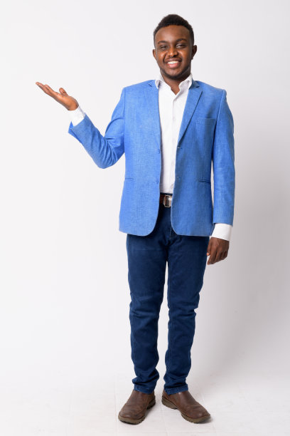 年轻快乐的非洲商人展示一些东西的全身照片图片下载