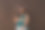 身着牛仔裤短裤和绿色上衣的孕妇双手搭在深棕色的腹部上。怀孕、分娩、准备和期望概念。美丽柔情的怀孕照片图片下载