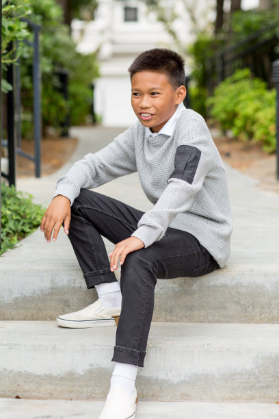 一个在外面微笑的年轻亚洲男孩的肖像。图片下载