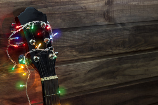 仿造spaсe，原声吉它指板上的新年花环，吉它在木墙下的花环图片下载