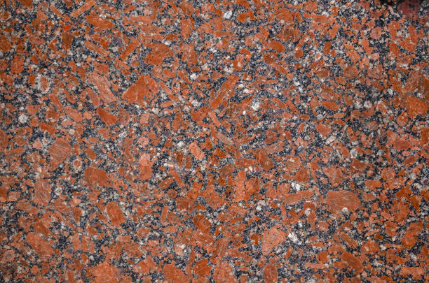 一个抛光的红色大理石花岗岩纹理的特写图片下载