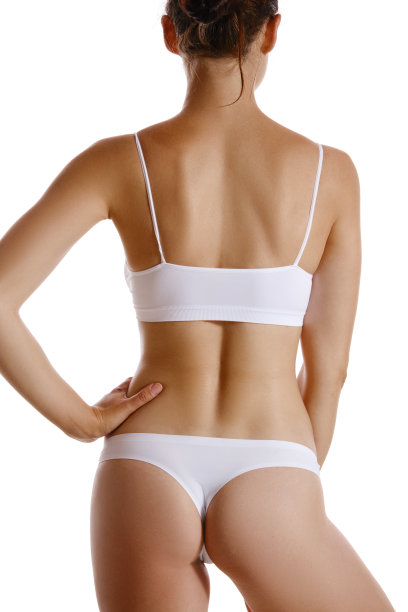 完美，苗条，年轻的身体，一个女孩在白色内衣摆姿势，孤立在白色。整形美容与美容概念。特写镜头图片下载