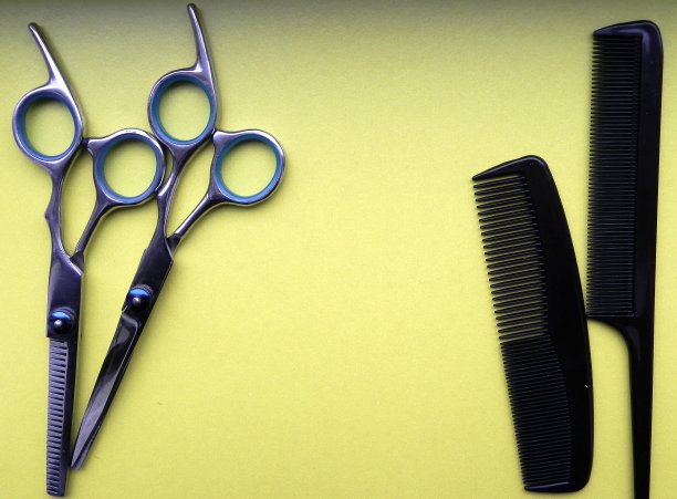 理发剪刀和梳子在黄色背景与文字空间图片下载