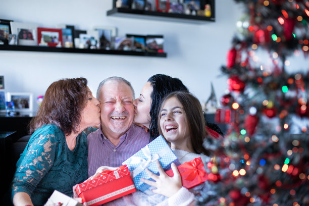 多代同堂在家里的沙发上送圣诞礼物图片下载