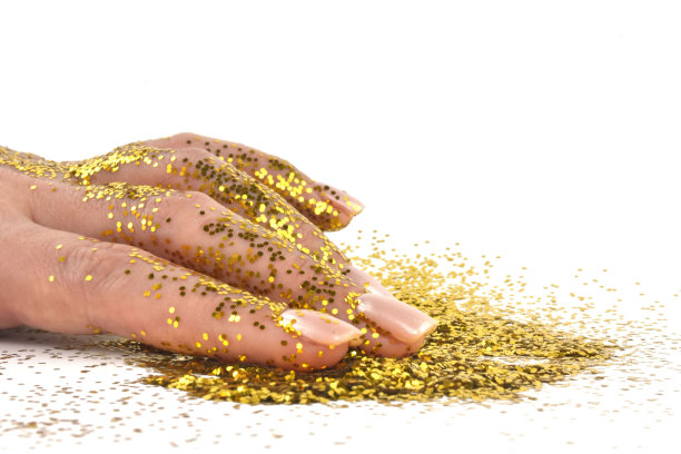 交上金光。金手指。女性手孤立在白色背景上有闪光。节日的概念。图片下载