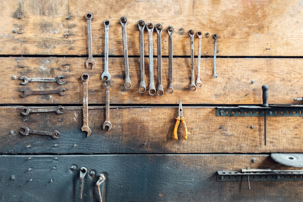 车间现场。车间墙上挂着的旧工具。复古车库风格。旧扳手挂在旧车库的墙上。图片下载