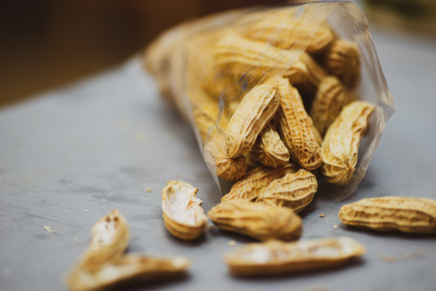 近距离观察蒸金黄花生。花生在科学上被称为花生。果仁混合在一个塑料袋里放在桌上图片下载
