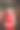 优雅的女人在红色的裙子与一杯香槟在派对上的假日发光的背景。图片下载