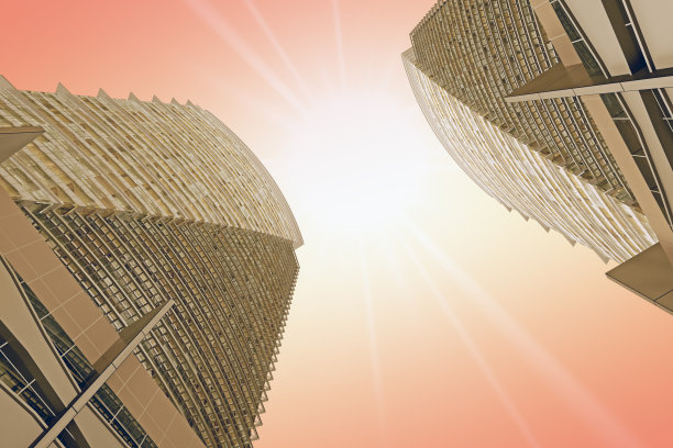 两个相同的摩天大楼在棕色色调的底部视图图片下载