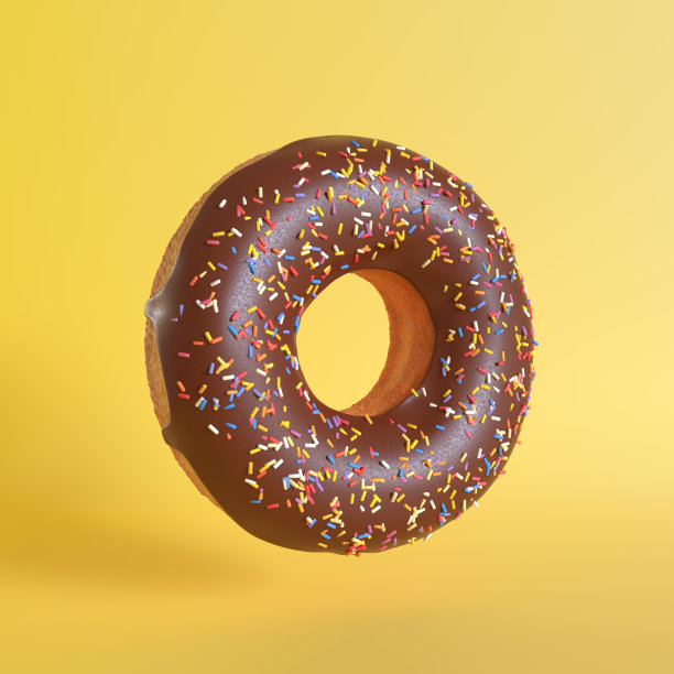 黄色背景上的巧克力甜甜圈图片下载