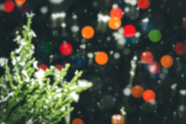 模糊的圣诞装饰和背景与冷杉树枝上五颜六色的散焦。图片下载