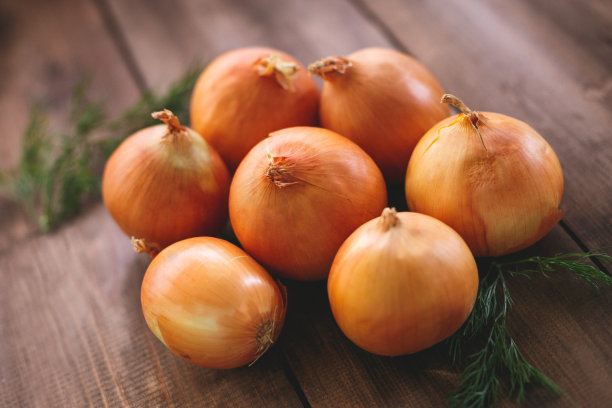 桌面上的洋葱由天然棕色木材制成图片下载