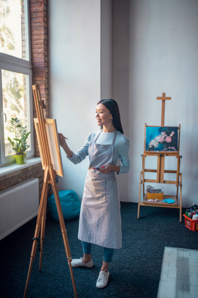 在演播室里穿着围裙的快乐年轻女人图片下载