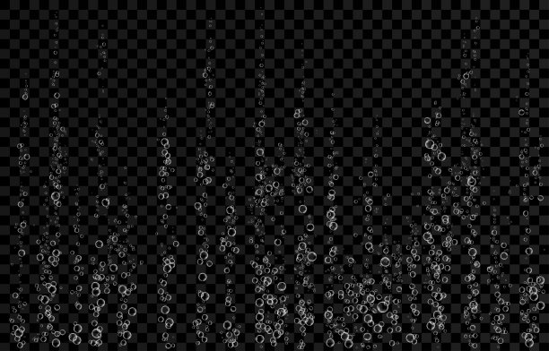 白色嘶嘶的气泡在水中的黑色背景。图片下载